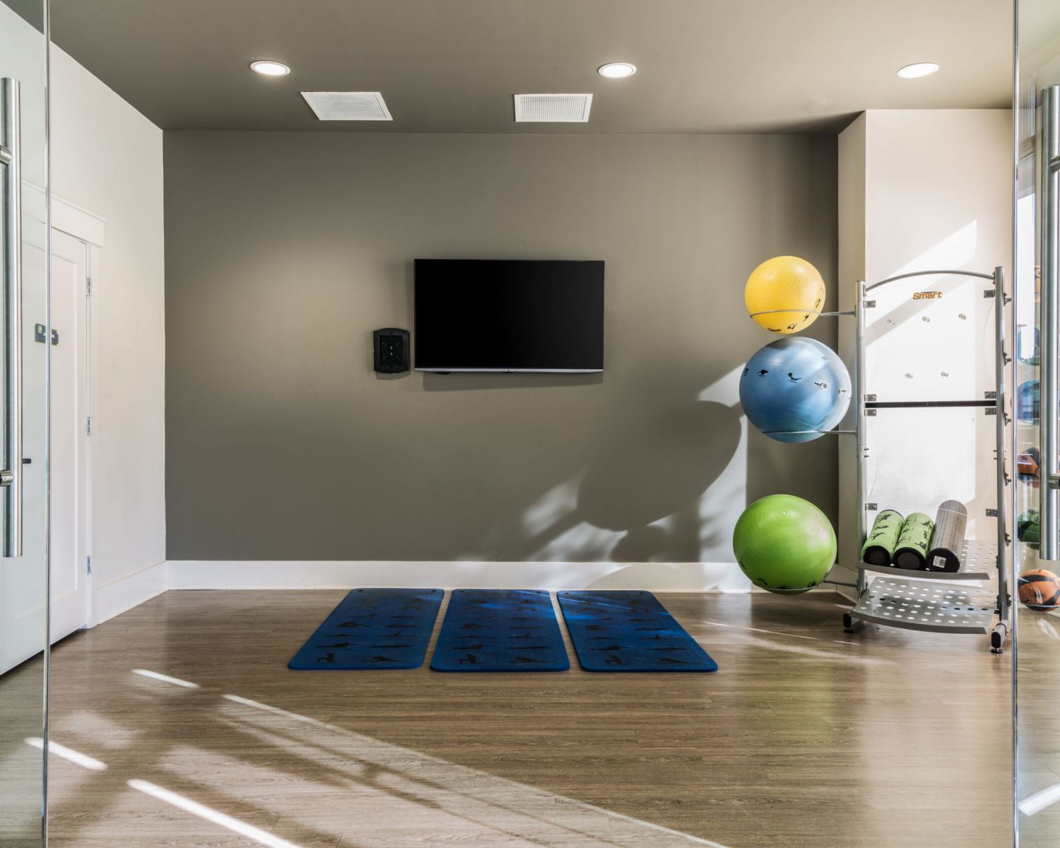 Apartments at Palladian Place with a workout and yoga room with equipment and a TV