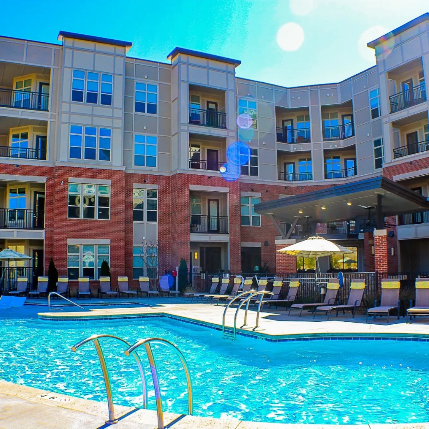 Apartments at Palladian Place building exterior and sparkling pool