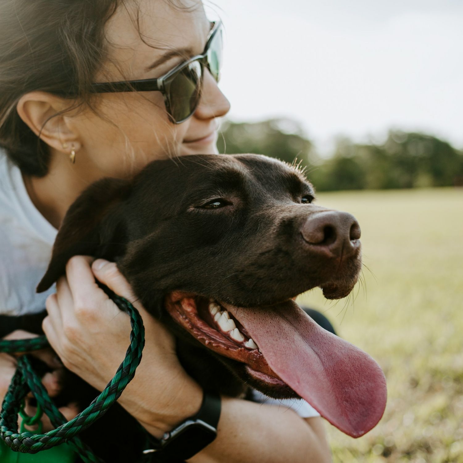 Apartments at Palladian Place in Durham, NC, a pet friendly community with a girl hugging her happy dog