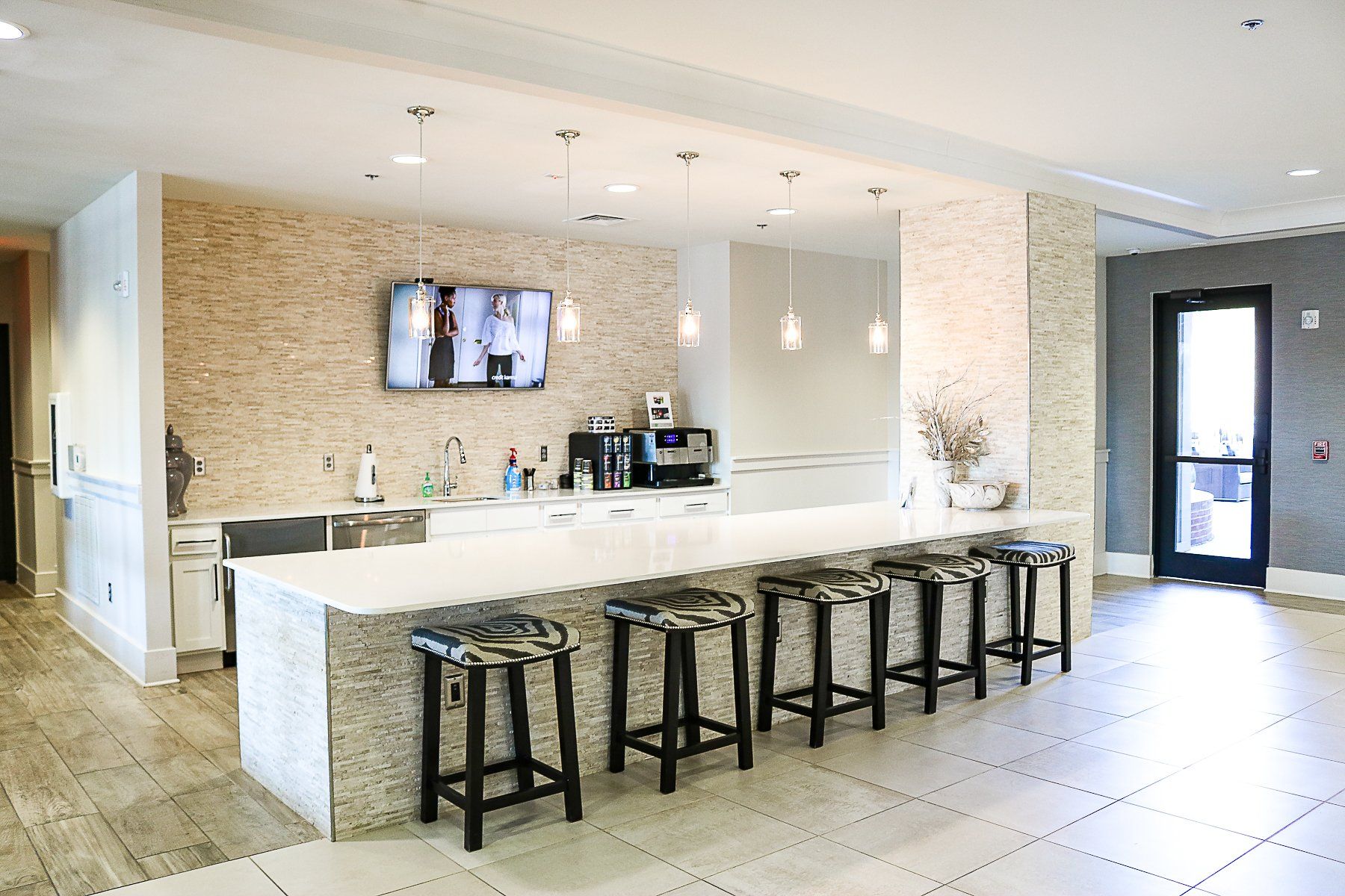 Apartments at Palladian Place with a large on-site barista bar with TV and bar stools