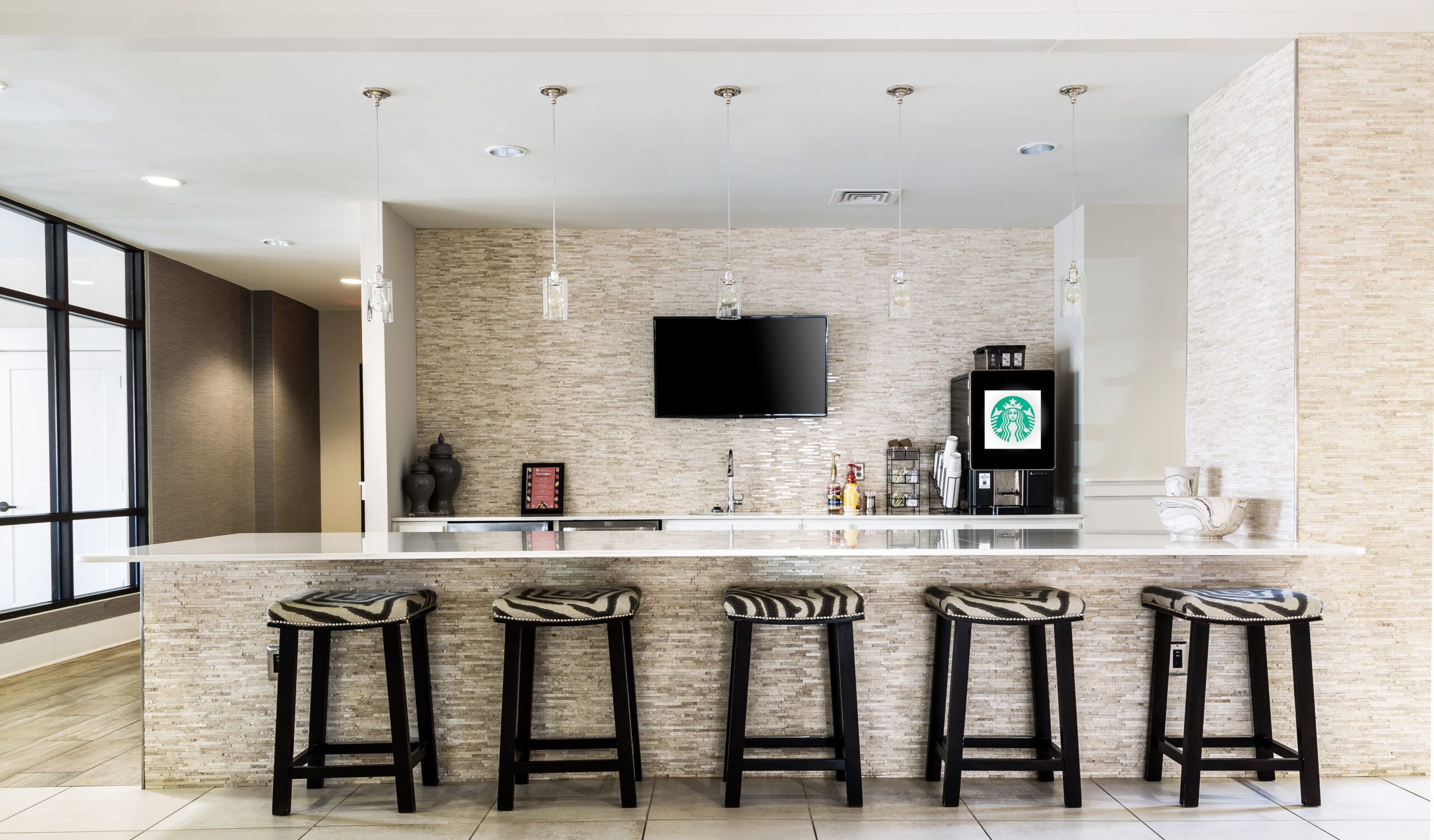 Apartments at Palladian Place with a large on-site barista bar with TV and bar stools