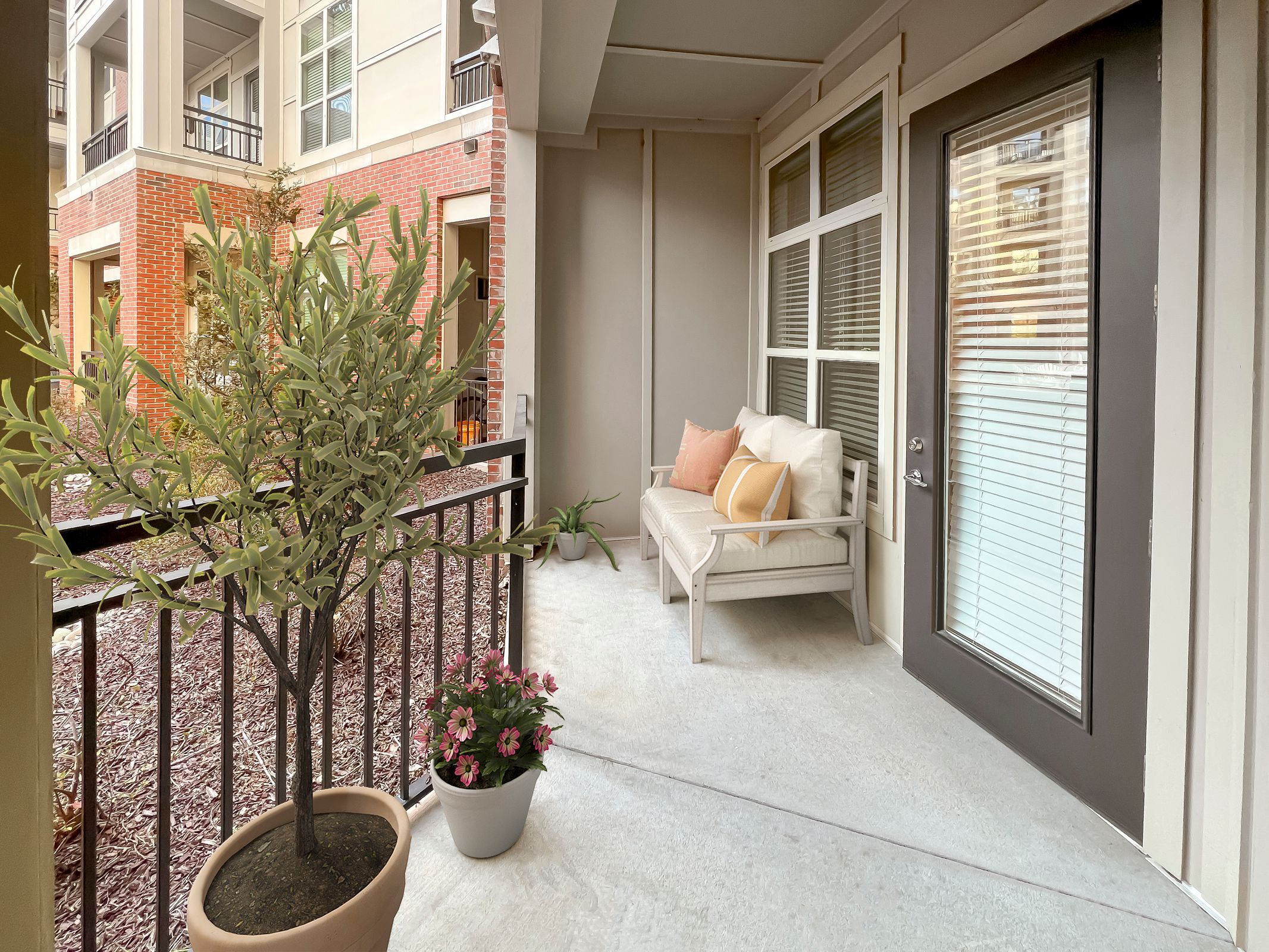 Apartments at Palladian Place in Durham, NC large covered patio with a love seat and plants
