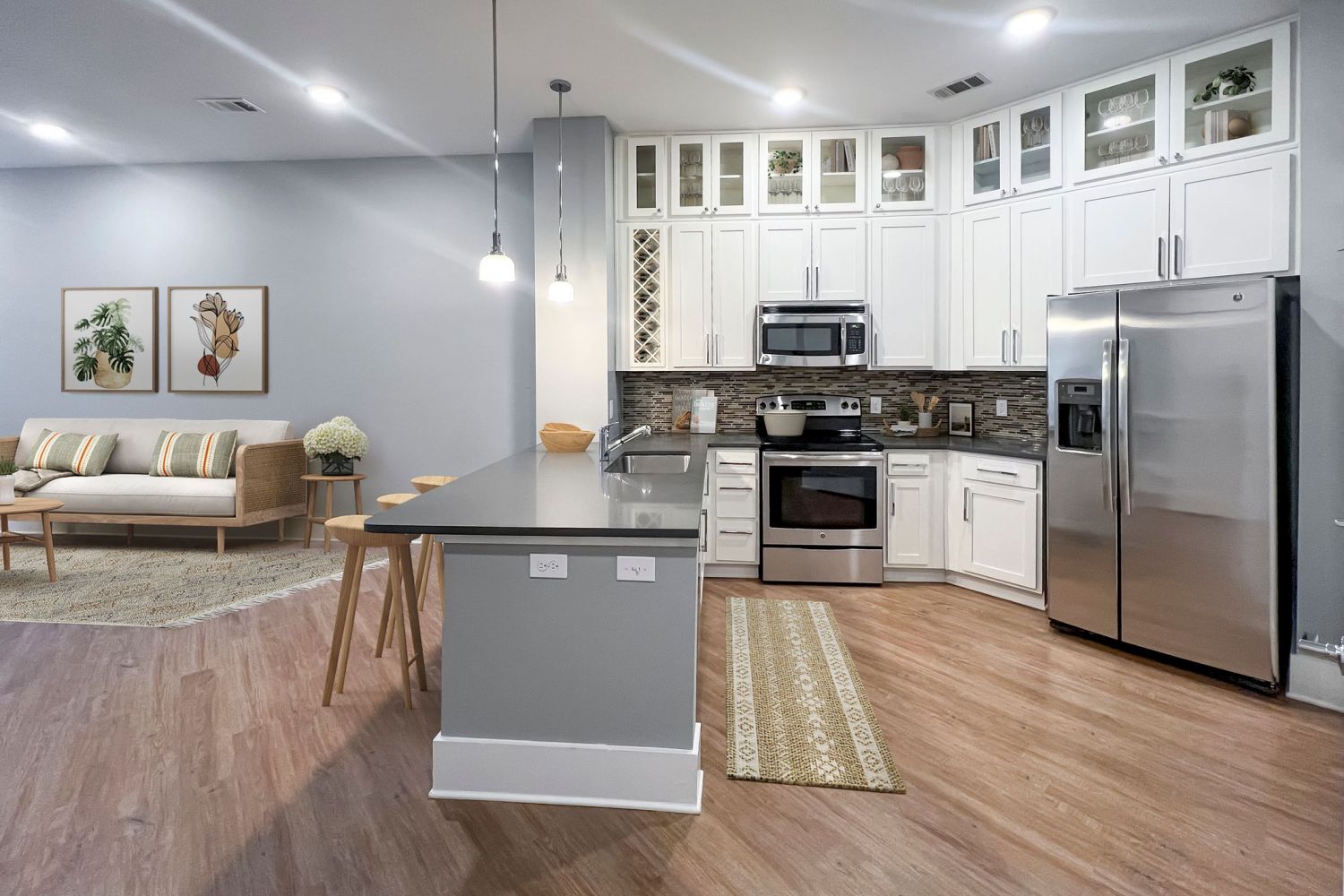 Apartments at Palladian Place in Durham, NC apartment interior kitchen with island, bar stools, plentiful storage space, and stainless steel appliances