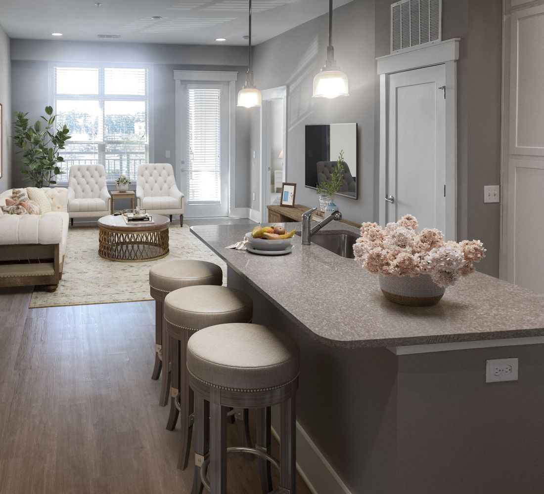 Apartments at Palladian Place in Durham, NC apartment interior kitchen with island, bar chairs, quartz countertops, and spacious open layout