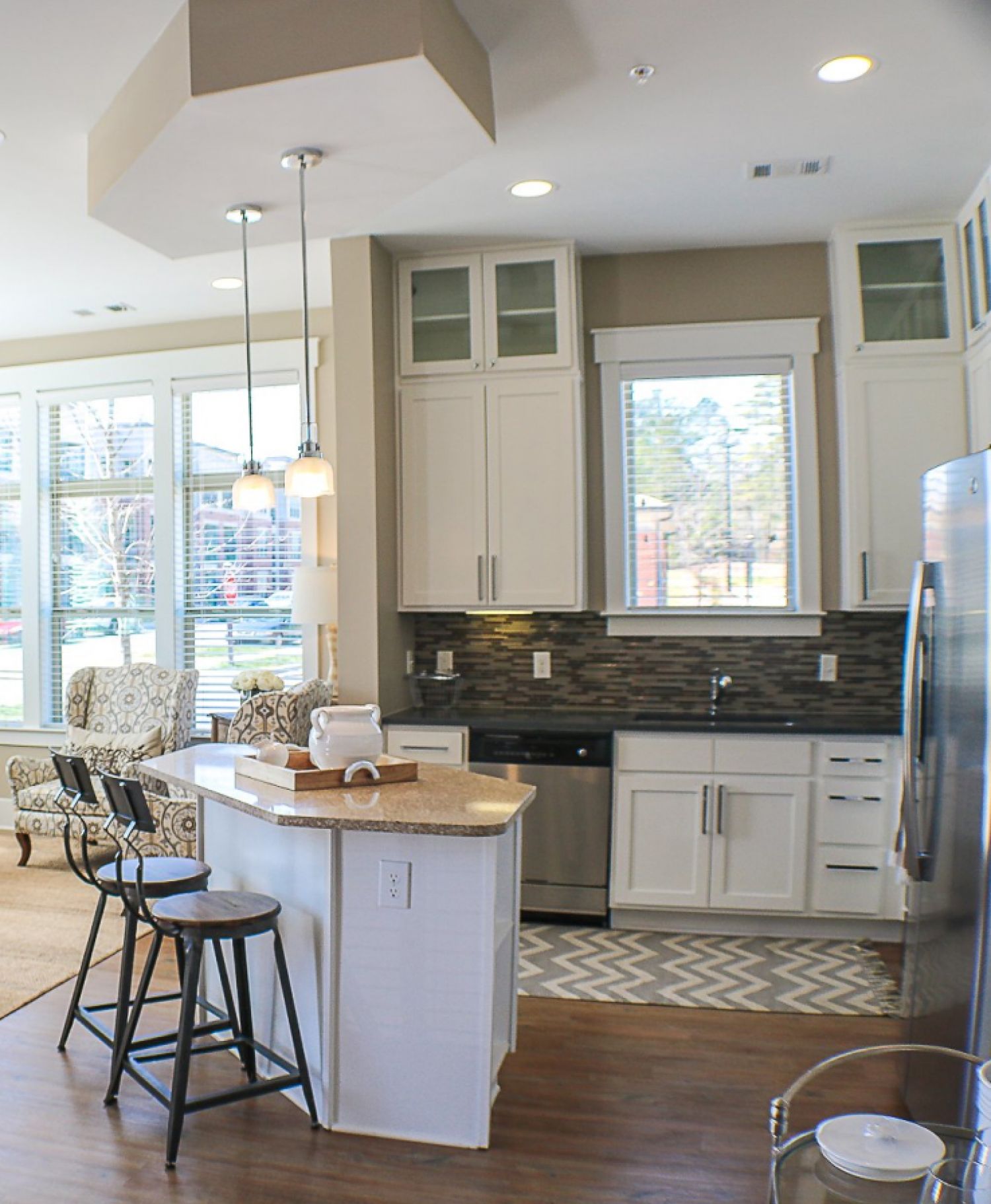 Apartments at Palladian Place kitchen with bar and bar stools, nice natural light, and abundance cabinet storage