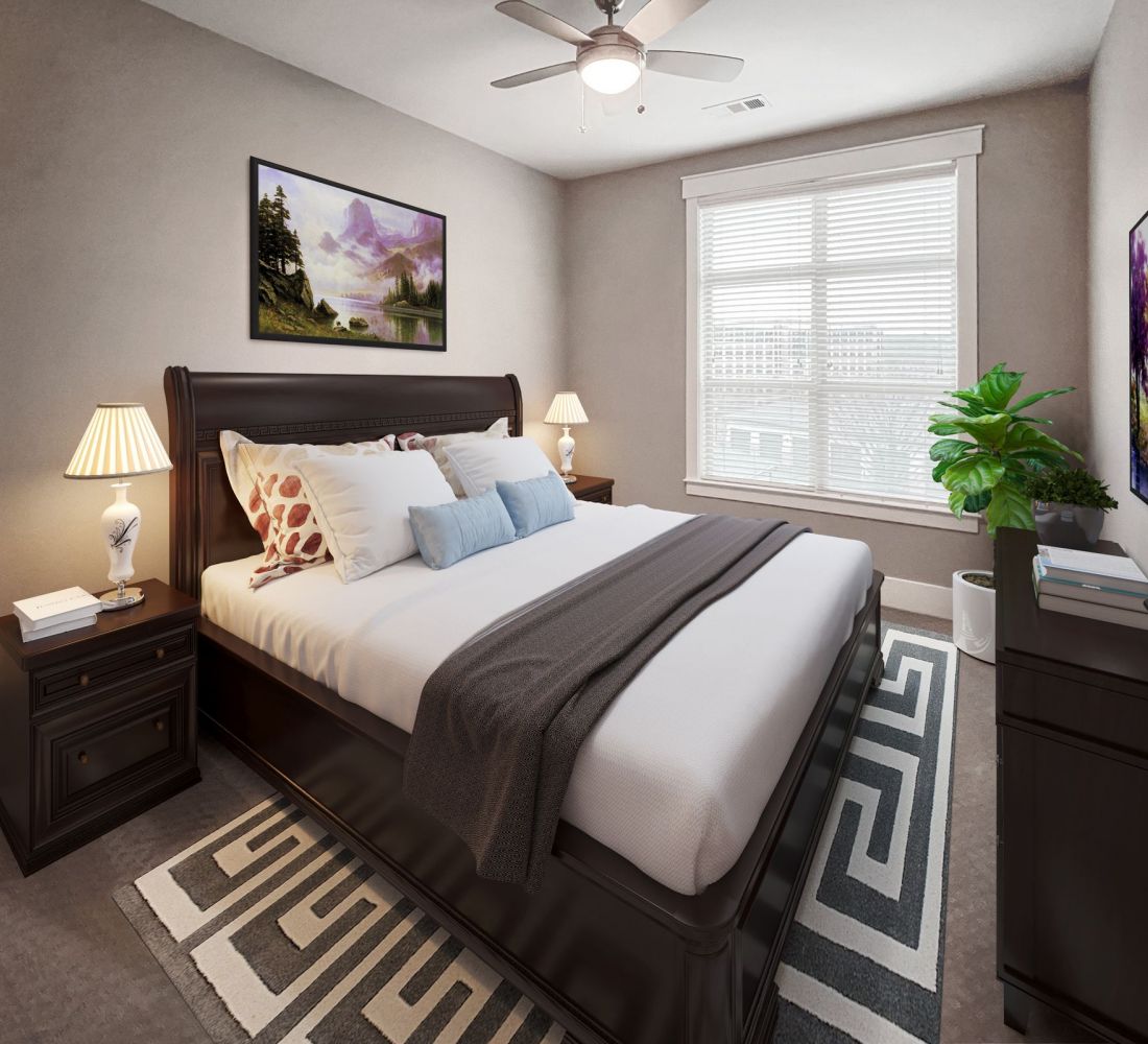 Apartments at Palladian Place in Durham, NC apartment interior bedroom with large bed, a rug, dresser, side table and lamp, and large windows