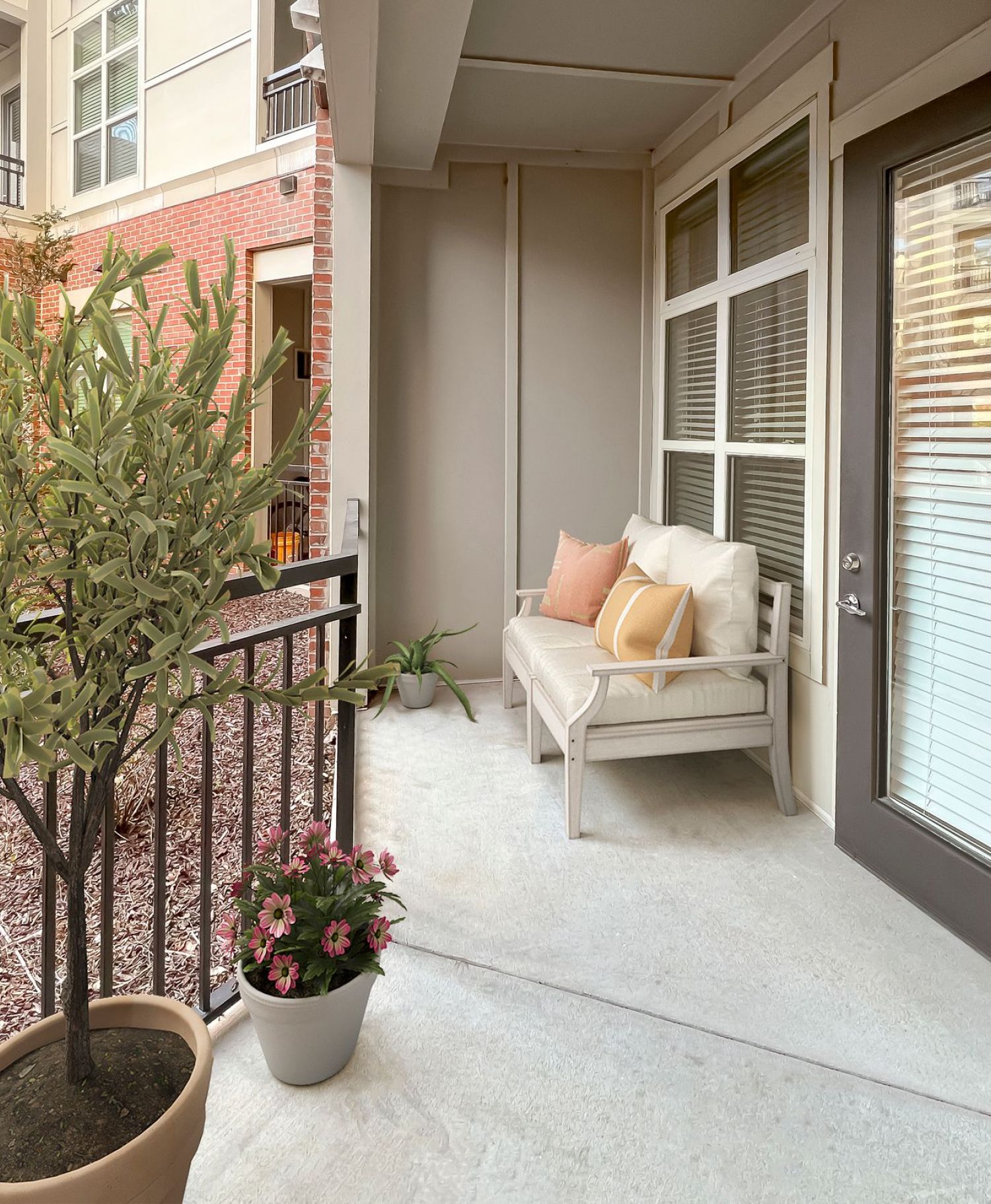Apartments at Palladian Place in Durham, NC large covered patio with a love seat and plants