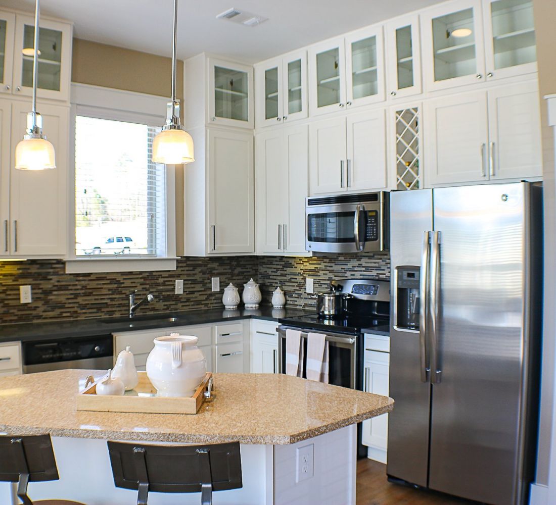Apartments at Palladian Place in Durham, NC apartment interior kitchen with island, bar chairs, plentiful storage space and cabinets, and stainless steel appliances